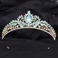 A delicate gold crystal bridal crown featuring light blue teardrop crystals and white leafy opal accents