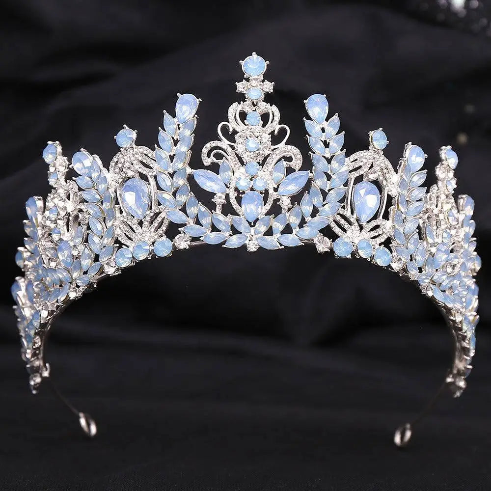 An elegant silver crystal bridal crown featuring white leafy opal and clear crystals in a delicate design