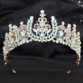 Ornate gold crystal bridal crown featuring white leafy opal and light blue crystals in a symmetrical design