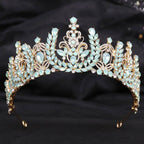 Ornate gold crystal bridal crown featuring white leafy opal and light blue crystals in a symmetrical design