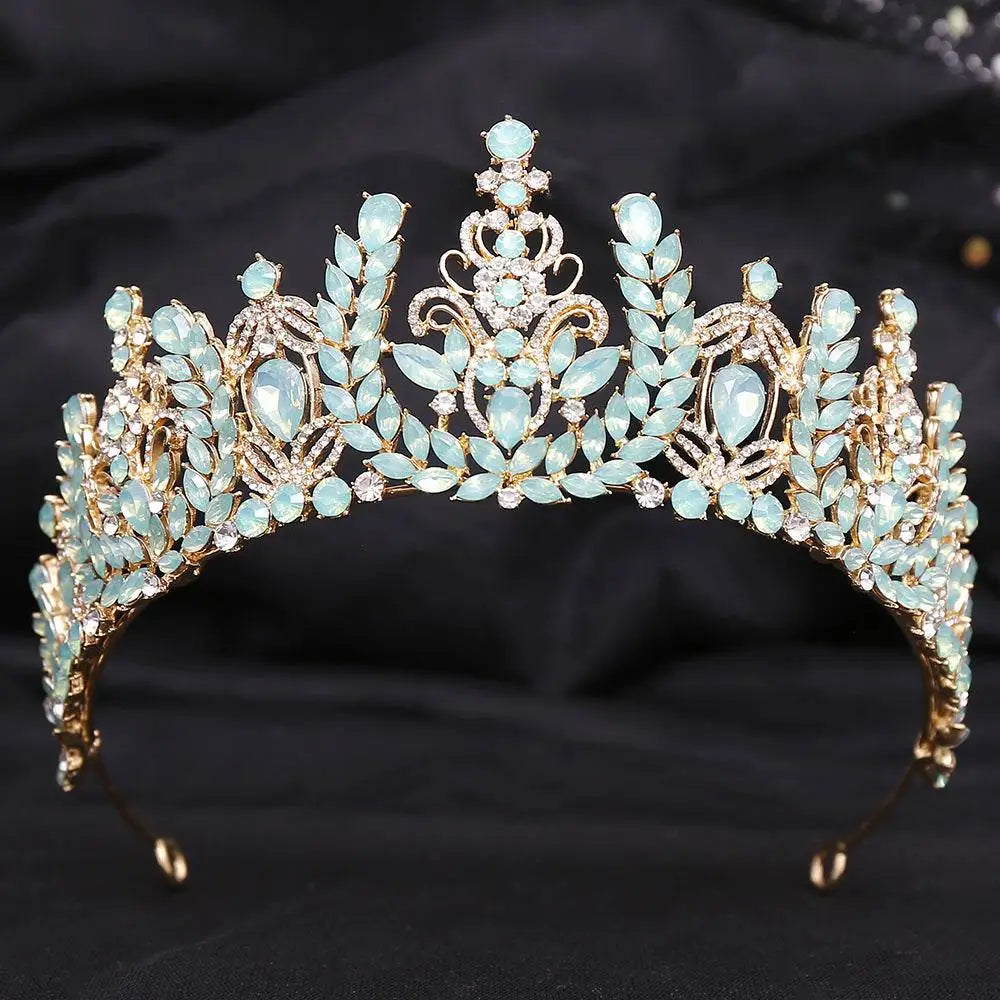 Ornate gold crystal bridal crown featuring white leafy opal and light blue crystals in a symmetrical design