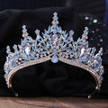 An elegant blue and silver crystal bridal crown featuring white leafy opal stones and faceted teardrop crystals