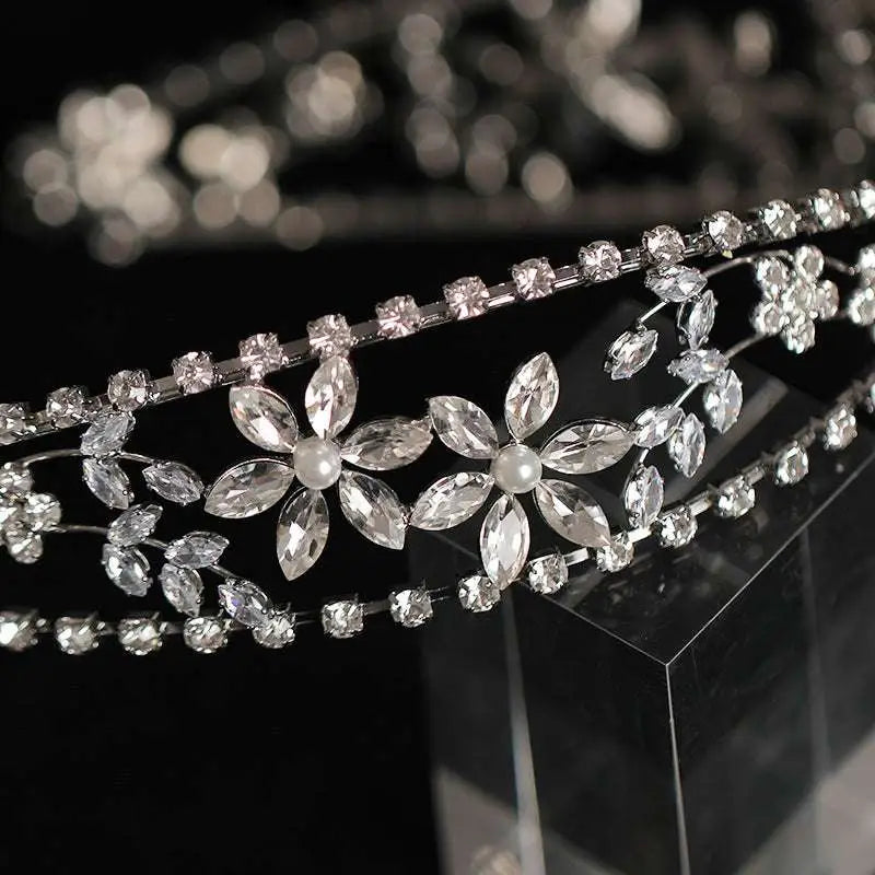 Silver zircon bridal crown headdress with delicate metal framework featuring floral crystals and a central starburst design