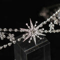 A silver zircon bridal crown headdress with delicate metal framework featuring sparkling rhinestones and floral crystals