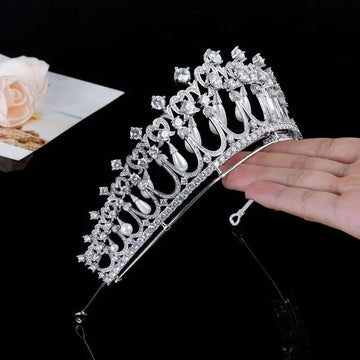Silver tiara bridal hair accessory featuring clear zircon crystals and dangling white pearls for weddings