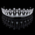 Silver tiara with clear crystals and dangling white pearls designed as bridal wedding hair accessory