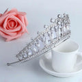Silver tiara adorned with sparkling zircon crystals and dangling white pearls for bridal wedding hair accessories