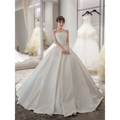 A simple elegant French style ivory satin wedding dress with a strapless bodice and flowing floor-length skirt