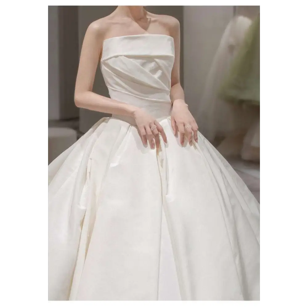 Simple elegant french style strapless ivory satin wedding dress with structured bodice and voluminous skirt
