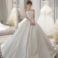 Simple elegant french style white satin wedding dress with strapless fitted bodice and voluminous skirt