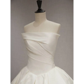 A sleek white satin wedding dress featuring a simple elegant french style with a draped off-the-shoulder bodice