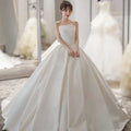 Simple elegant french style strapless white satin wedding dress with fitted bodice and voluminous skirt