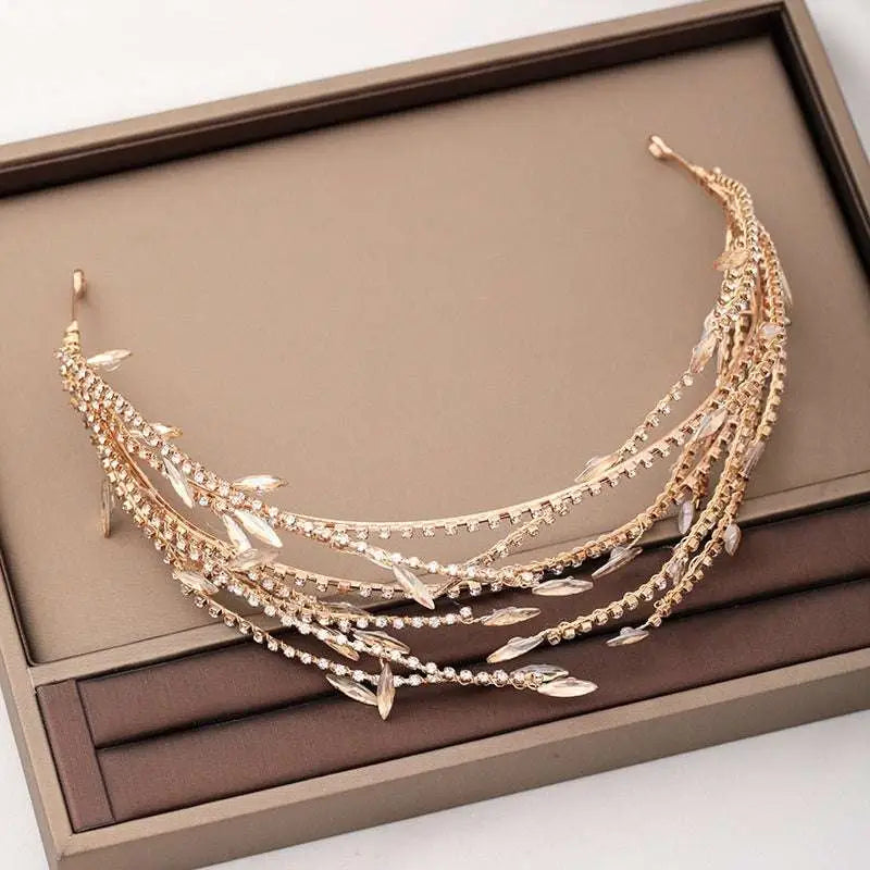 A delicate golden alloy double mesh rhinestone headband featuring leaf-shaped embellishments and sparkling details