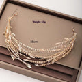 A delicate golden alloy double mesh rhinestone headband featuring layered leaf-shaped charms and sparkling rhinestones