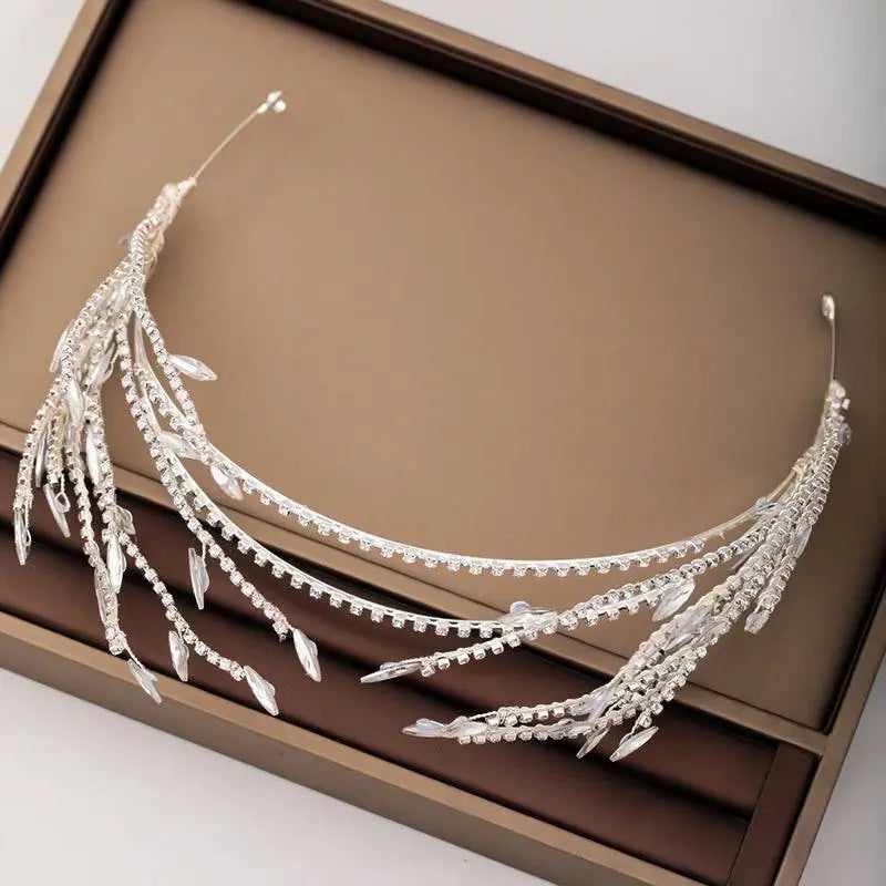 Elegant silver tiara adorned with cascading crystal leaves and rhinestones in a golden alloy double mesh rhinestone headband featuring design