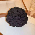 Black fabric rose hair clip with layered ruffled petals made of textured fabric for elegant simple graceful barrettes