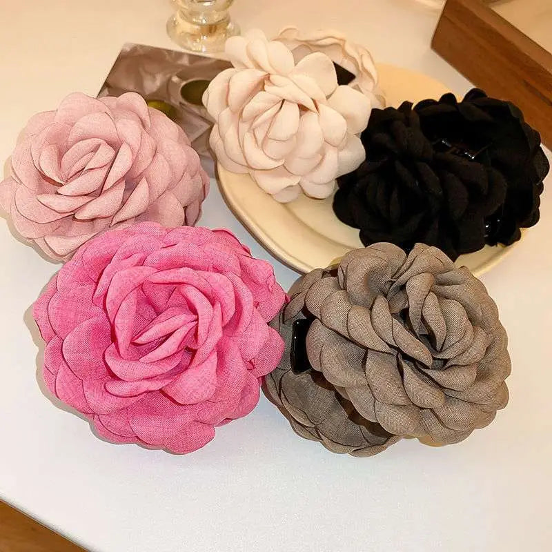 Simple graceful barrettes featuring pink gray and navy blue ruffled fabric flowers with layered ruffled petals