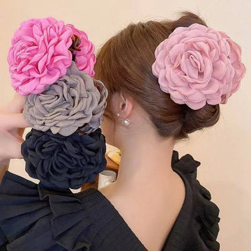 Simple graceful barrettes featuring pink gray and navy blue ruffled fabric flowers with layered ruffled petals