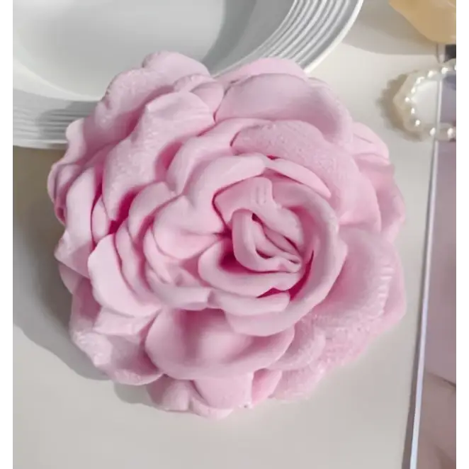 Simple graceful barrettes featuring a delicate pink fabric rose with layered ruffled petals and subtle sheen
