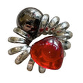 A shiny chrome spider-shaped phone line hair ring with a translucent red love heart for graceful red love style