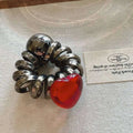 A simple graceful red love phone line hair ring featuring a glossy red heart-shaped glass charm and coiled silver band