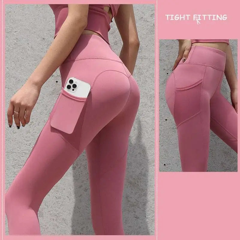 Pink high-waisted gym sport seamless leggings with side pocket holding smartphone for active use