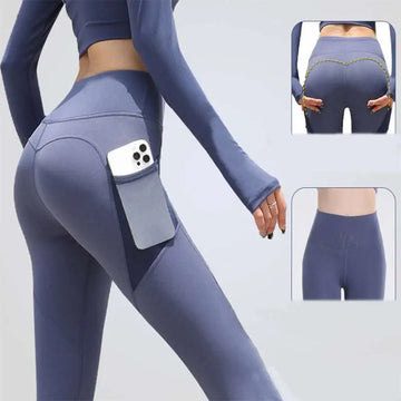 A pair of slate blue high-waisted gym sport seamless leggings with a side pocket holding a smartphone