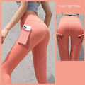 Coral pink high-waisted gym sport seamless leggings with built-in side pocket holding a smartphone