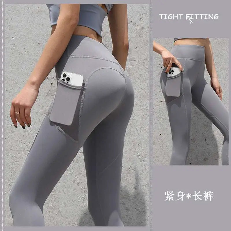 Slate blue gym sport seamless leggings high waisted with built in side pocket holding a smartphone