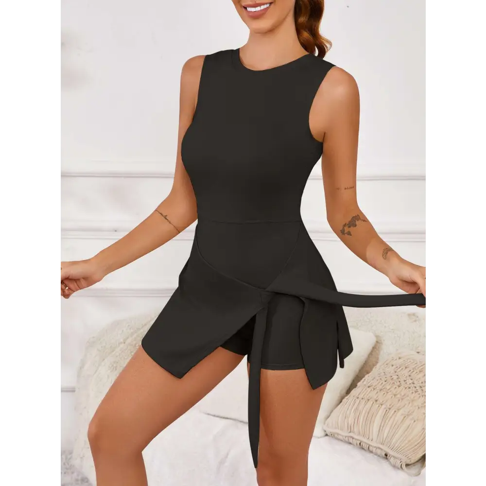 Black sleeveless side slit yoga tennis skirt sport dress with a tied waistband and peplum detail in cream-colored fabric