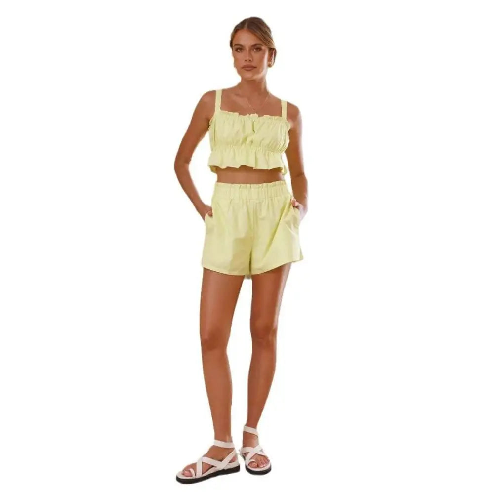 A light yellow ruffled crop sleeveless suspender shorts two-piece set with thin straps and high-waisted shorts