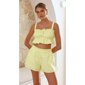 A vibrant lime green sleeveless suspender shorts two-piece set with a ruffled crop top and high-waisted shorts