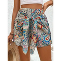 Slimming lace up printed irregular skirt with vibrant colorful paisley-patterned slimming fabric in blue red and cream