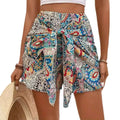 Slimming lace up printed irregular skirt in colorful paisley-patterned blue red and cream fabric with tied waistband