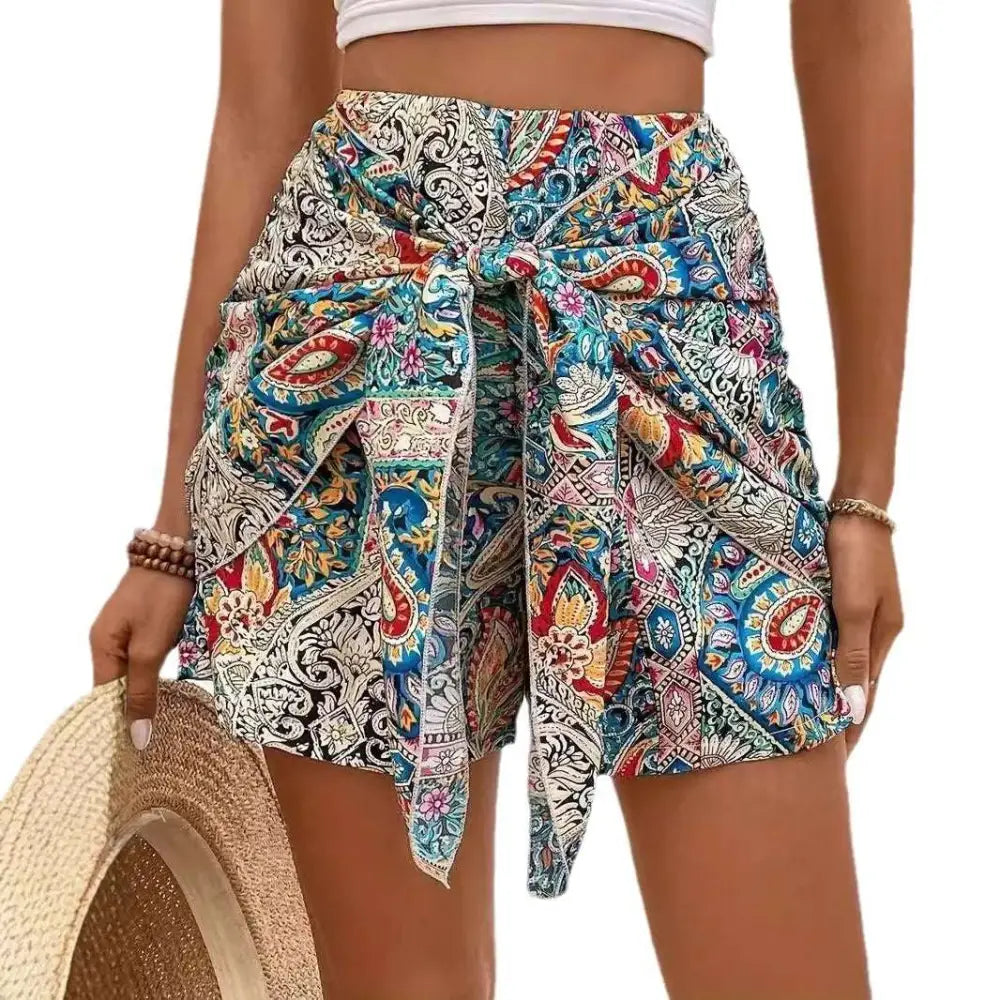 Slimming lace up printed irregular skirt in colorful paisley-patterned blue red and cream fabric with tied waistband