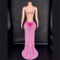 Back view of a pink sling super shiny beaded evening gown featuring intricate silver beading and a sequined heart detail