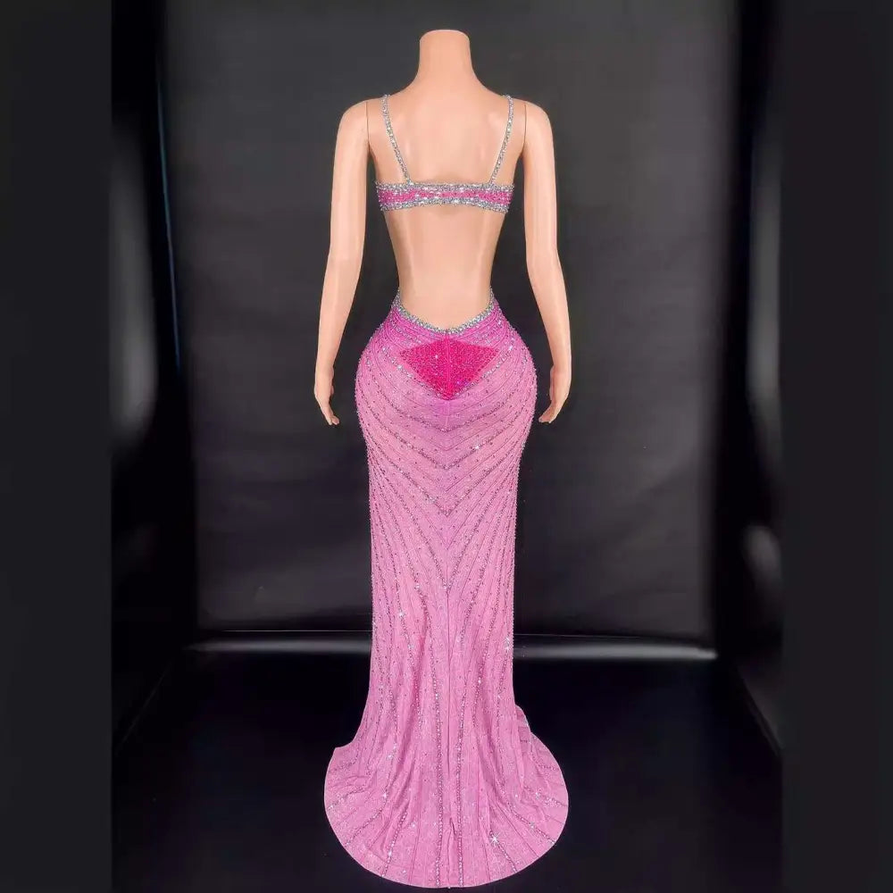 Back view of a pink sling super shiny beaded evening gown featuring intricate silver beading and a sequined heart detail