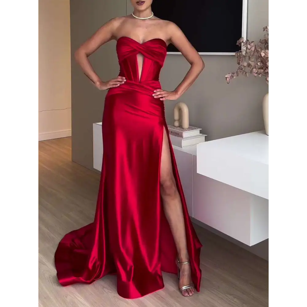 A striking red satin strapless evening dress with a fitted bodice and high slit long satin strapless design