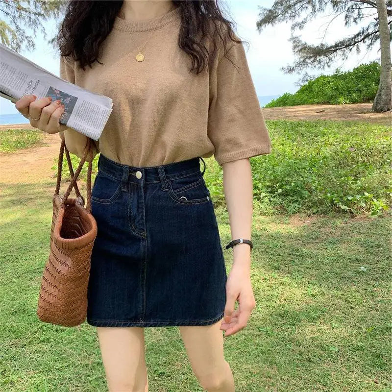 Small denim skirt in summer dark blue with high waist and front pockets made of denim material