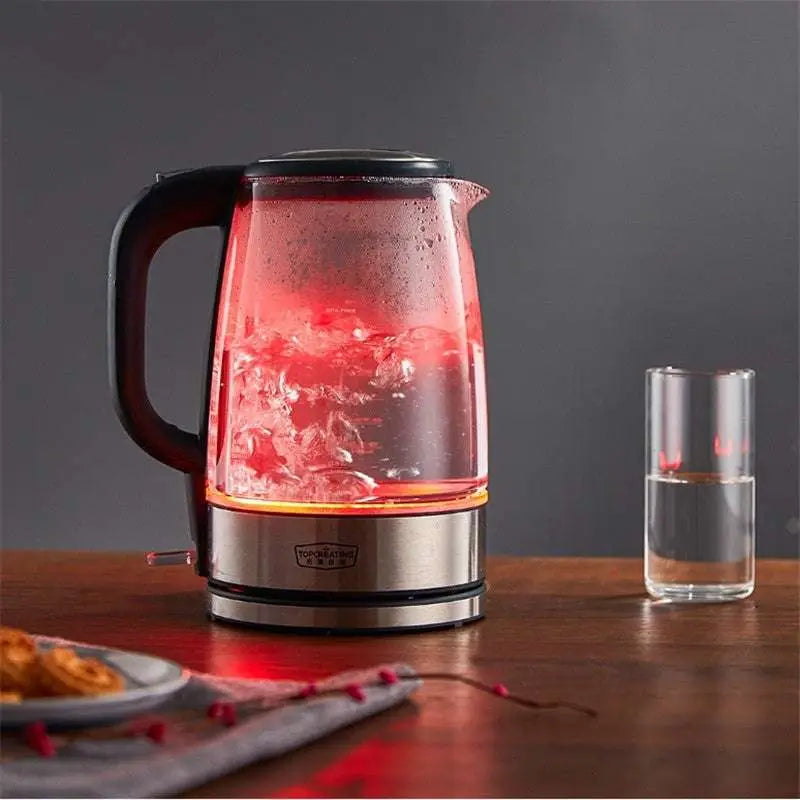Small glass electric kettle with red led light, black handle, and stainless steel base for quick boiling