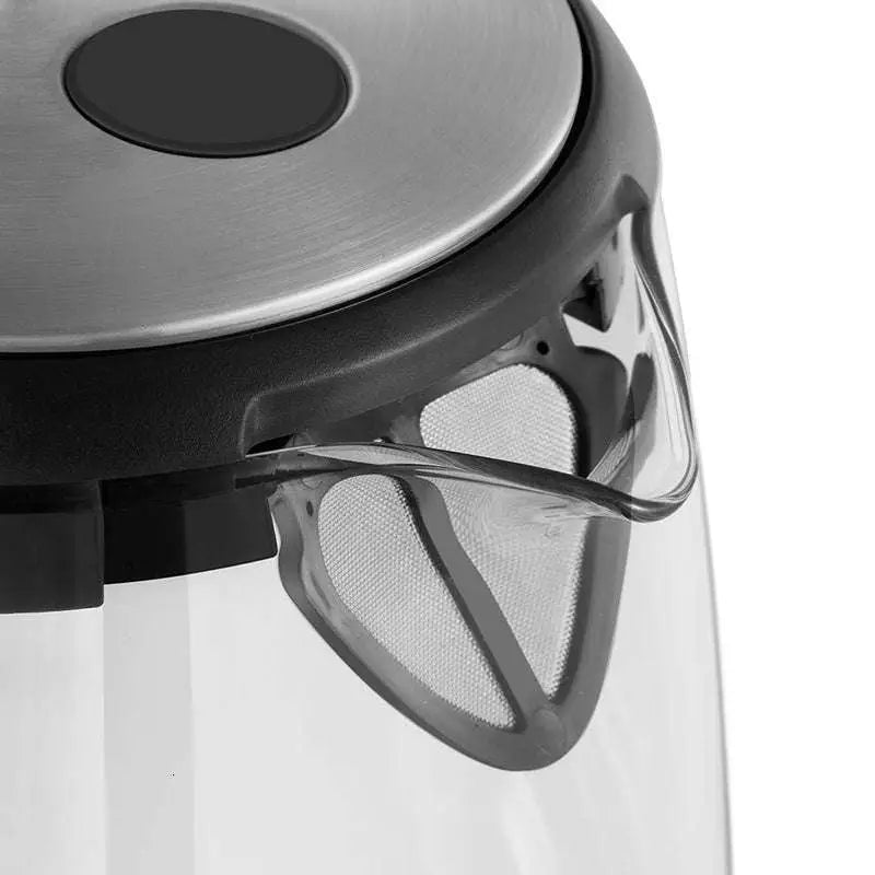 Small glass electric kettle with stainless steel base, transparent body, black accents, integrated mesh filter, and red led light
