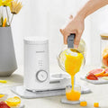 White boboduck baby kitchen small multifunctional complementary food machine with gray handle pouring orange puree