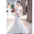 Small trailing temperament sleek white satin mermaid wedding dress with strapless sweetheart neckline and bow detail at the back