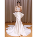 A sleek white satin small trailing temperament mermaid wedding dress with a fitted bodice and flared skirt