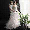 Strapless white small trailing wedding gown with intricate lace bodice and layered tulle skirt elegant design