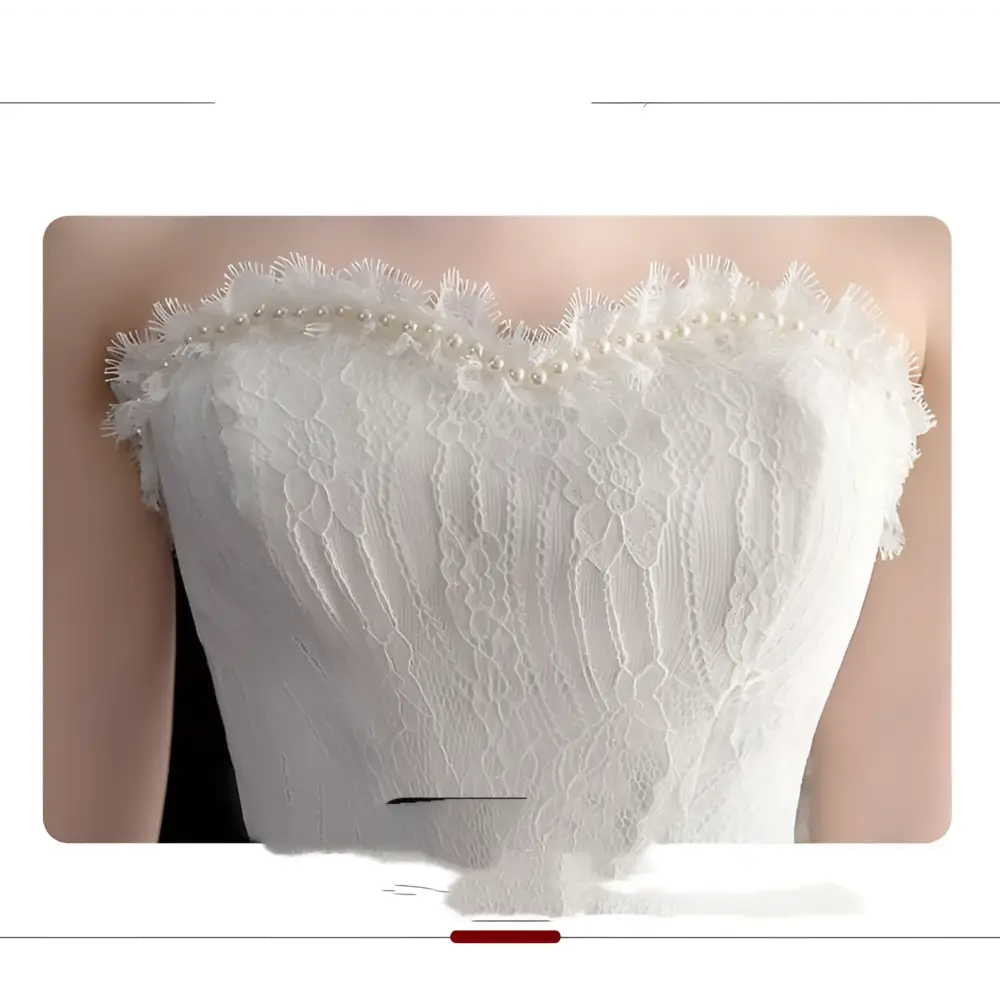White small trailing wedding dress with strapless lace bodice pearl embellishments and layered tulle skirt