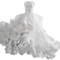 A white small trailing wedding dress with a fitted bodice and layered tulle skirt for elegant occasions