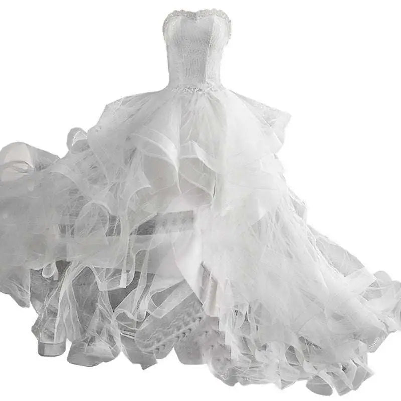 A white small trailing wedding dress with a fitted bodice and layered tulle skirt for elegant occasions