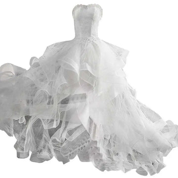 A white small trailing wedding dress with a fitted bodice and layered tulle skirt for elegant occasions