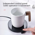 White ceramic smart coffee mug with wooden handle on black coffee mug warmer with three temperature settings